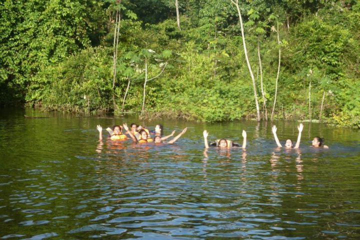 People swimming in the Amazon jungle