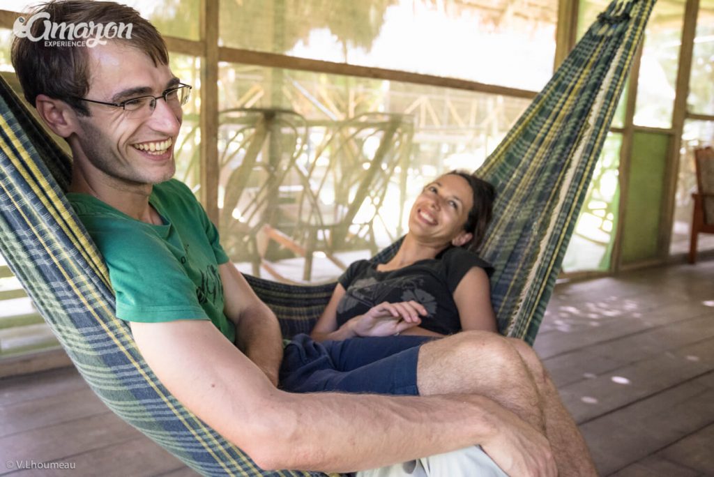 Happy couple relaxing on Amazon Experience lodge