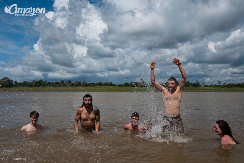 People jumping in the Amazon river